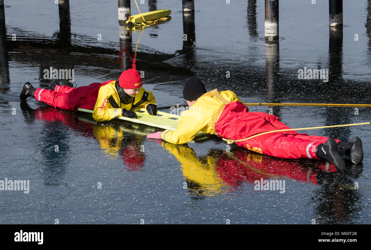 27 February 2018, Germany, Berlin: The lifeguards Franziska Hildner (L) and Felix Buelk of the German Life Saving Association (DLRG) present a rescue of a person who fell into the ice in front of media representatives. The DLRG informed about the fatalities by drowning in Germany in 2017 during a press conference. Photo: Bernd von Jutrczenka/dpa Stock Photo