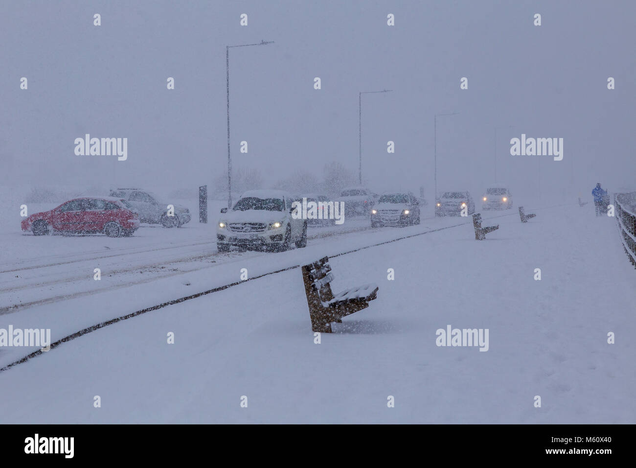 Cars Struggle Along Seafront at Thorpe bay near Southend-on-Sea, Essex. 27th Feb, 2018. Very unusual weather conditions for this part of south east England, heavy snow driven in from the east on bitterly cold winds said to come all the way from Siberia. What traffic there was found conditions difficult with not many people venturing out. Those which did made the most of the conditions Credit: Timothy Smith/Alamy Live News Stock Photo