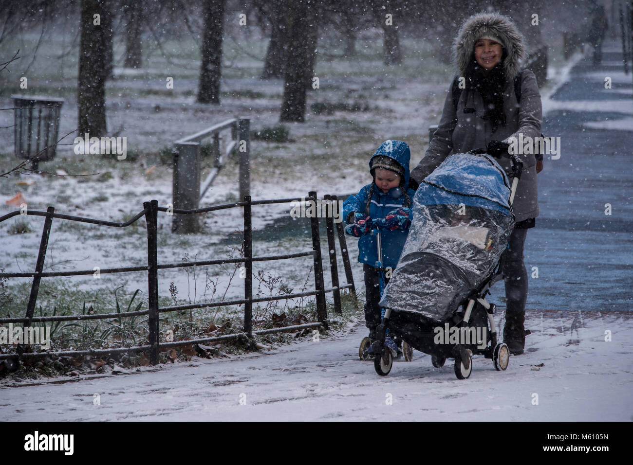 London, UK. 27th Feb, 2018. Commuters and families face a miserable journey back from Clapham South Underground as the snow falls in freezing temperatures in Clapham. Credit: Guy Bell/Alamy Live News Stock Photo