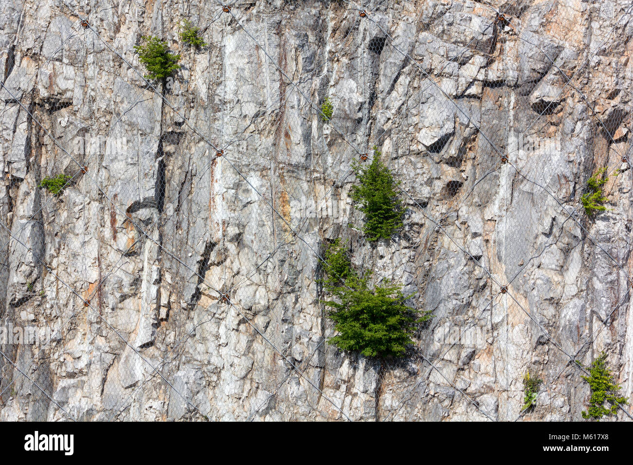 Mesh In Rocks Karst rock face wrapped up in a wire mesh to contain the collapsing of ...