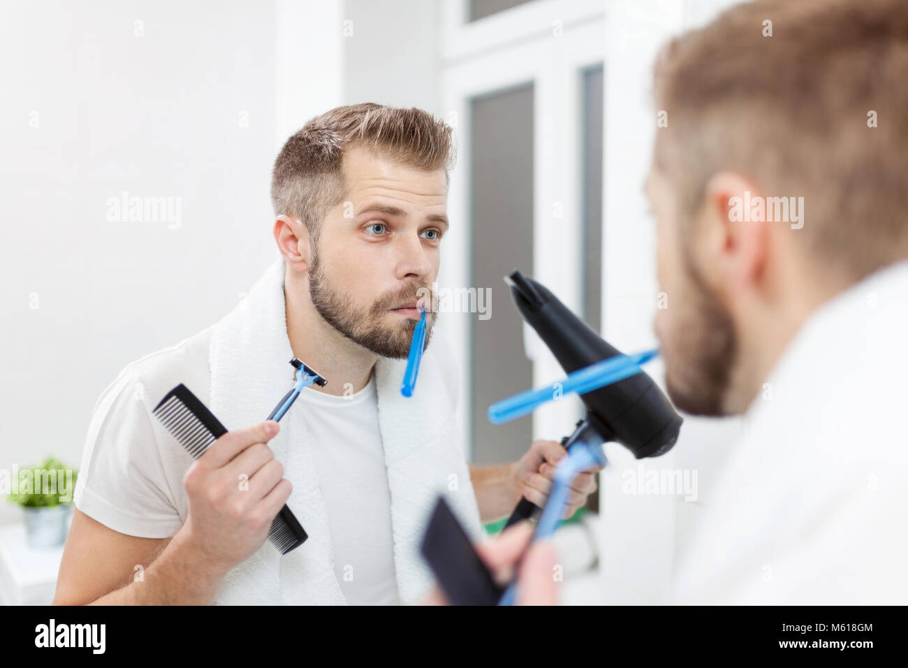 Morning hygiene, Handsome man in the bathroom and his morning routine ...