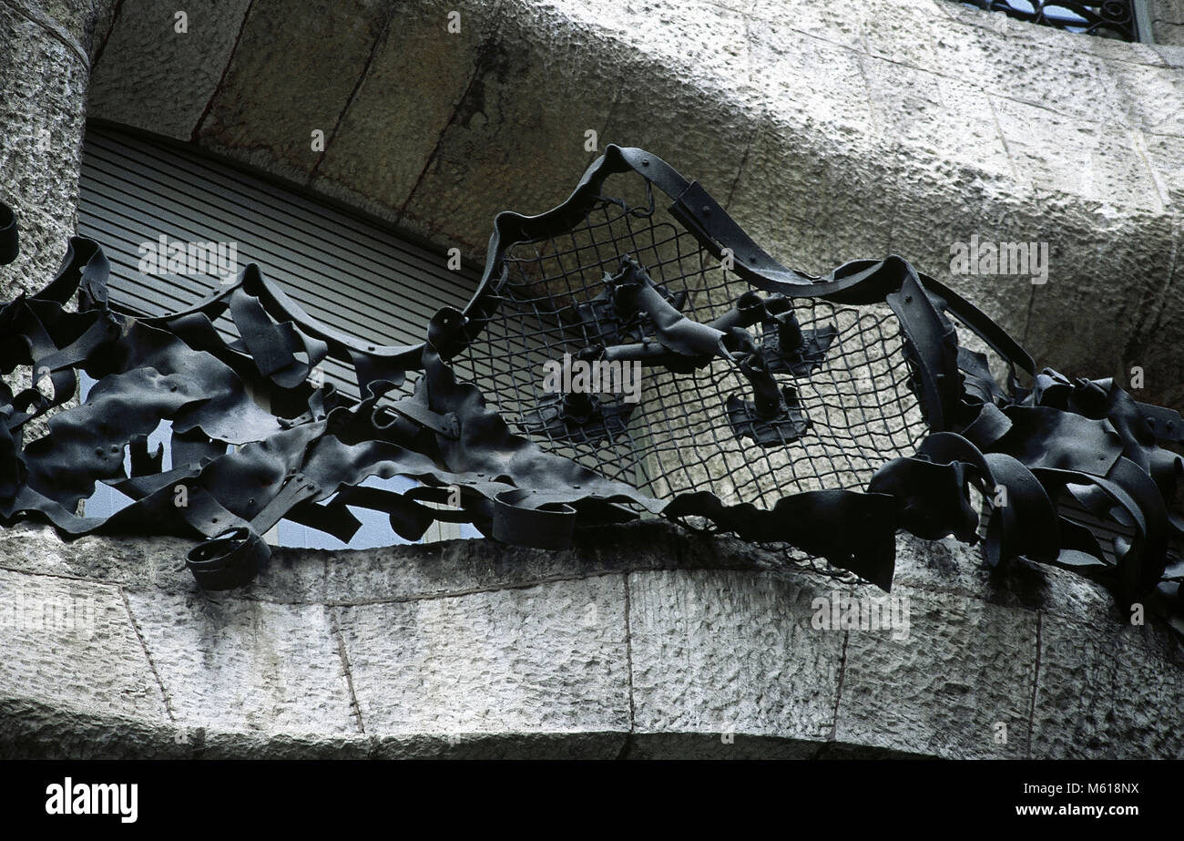 Spain, Barcelona. Casa Mila by Antonio Gaudi, 1906-1912. Detail of the facade. Balcony. Wrought iron work. Smiths Lluis Badia i Miarnau and Josep Badia i Miarnau. Stock Photo