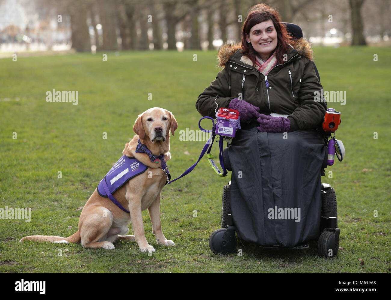 Clare Syvertsen, 29, from Notholt in London, with her Labrador/Golden Retriever cross Griffin, during a photocall by The Kennel Club in Green Park, London, to announce the finalists for the Crufts dog hero competition, Friends for Life 2018. Stock Photo