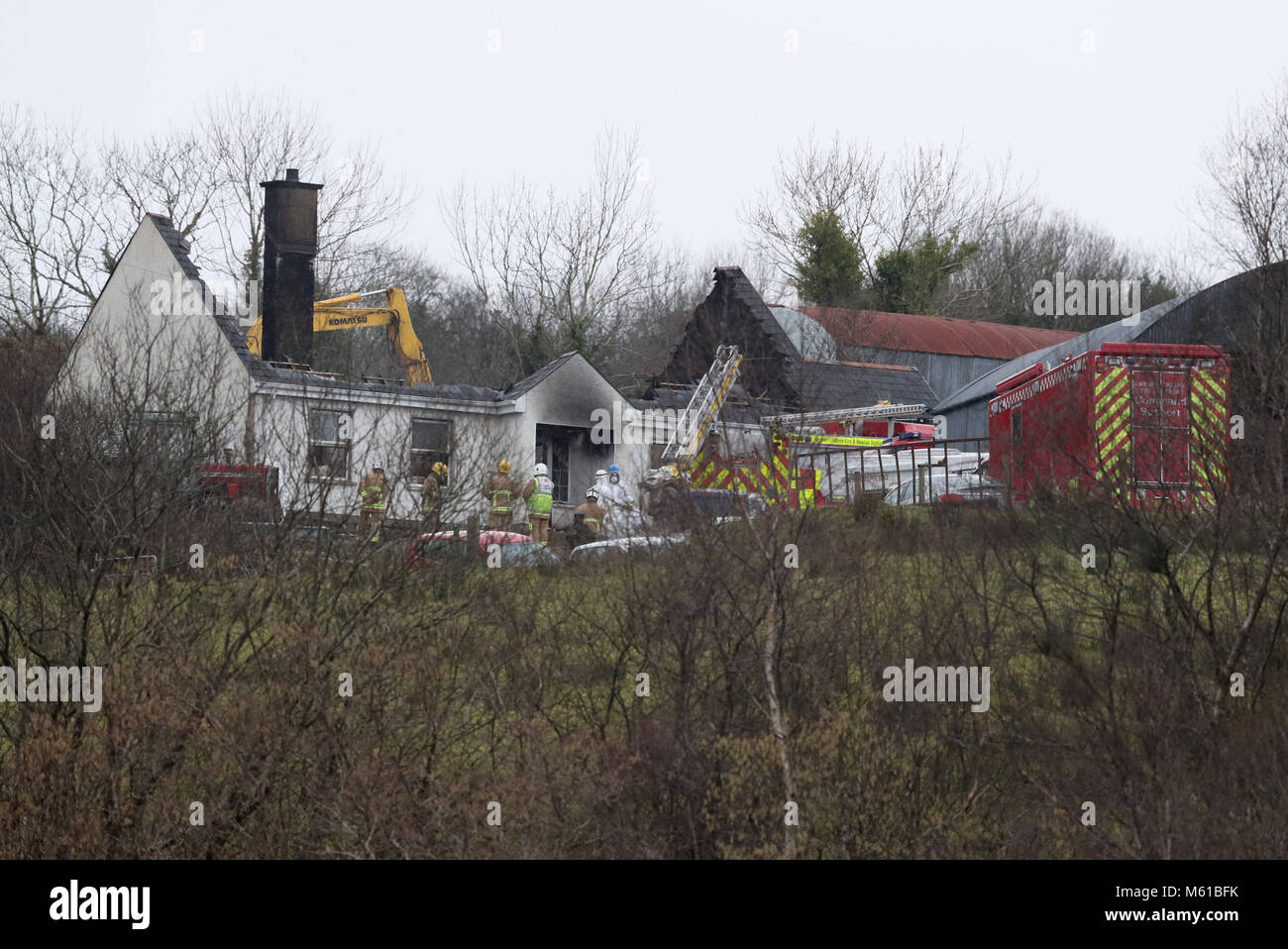 Forensic and fire officers at a house in Derrylin, Fermanagh where three people have died in a fire and police have arrested a man at the scene on suspicion of murder. Stock Photo