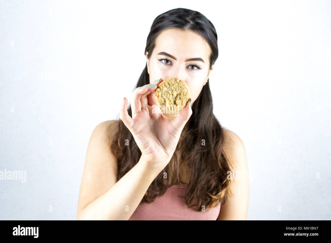 young girl holding cookie Stock Photo Alamy