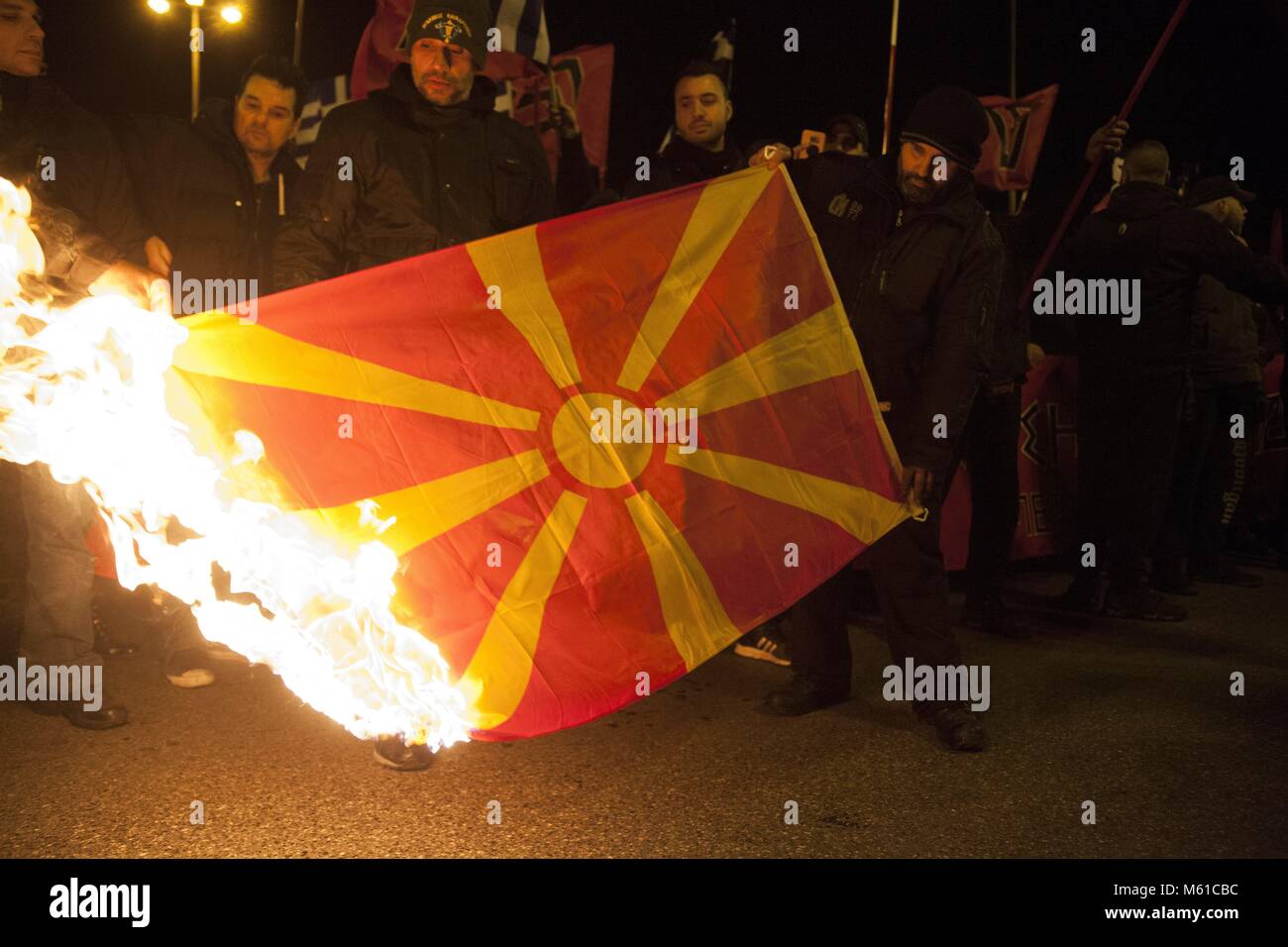 Supporters of Greek Chrysi Avgi (Golden Dawn), far-right nationalist party, burn flag of FYROM during rally in Athens. 03.02.2018 | usage worldwide Stock Photo