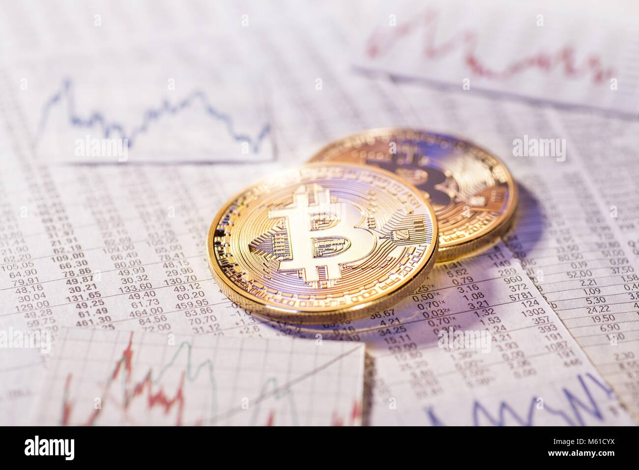 Two Bitcoin Coins With Tables And Graphs With Foreign Exchange Rates - 