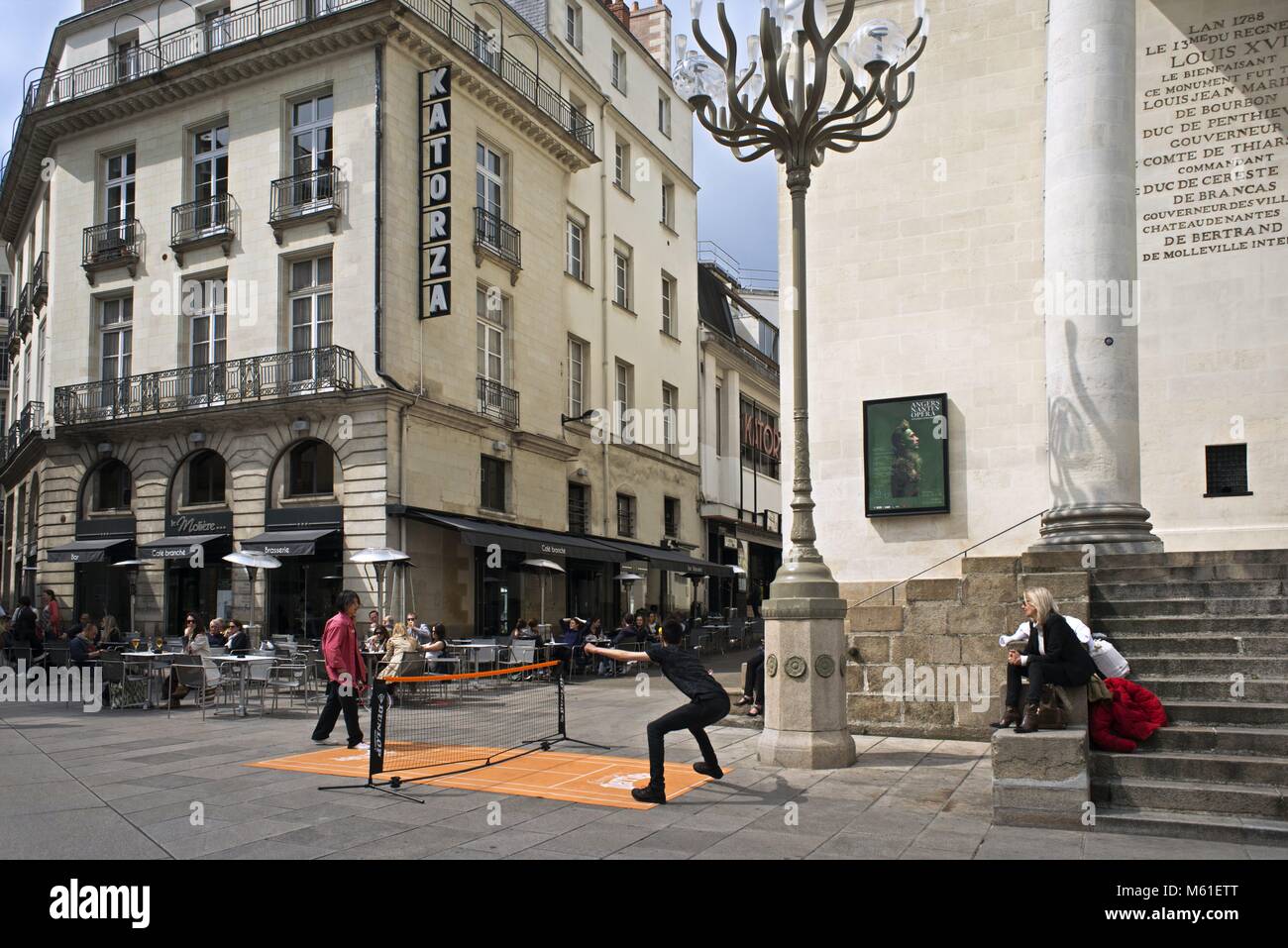 People Playing Mini Tennis In Front Of A Graslin Theater In The