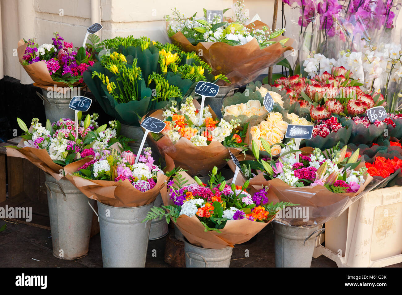 Various flower bouquets in baskets with price tags for sale at a street market in England Stock Photo