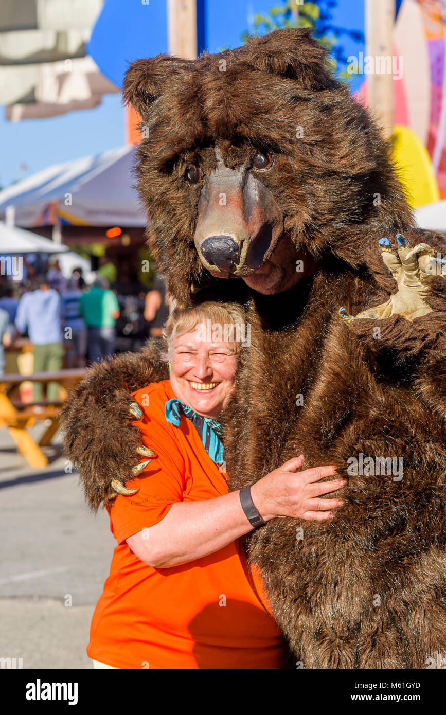 Mortal Coil Roving performer in bear costume interacts with woman