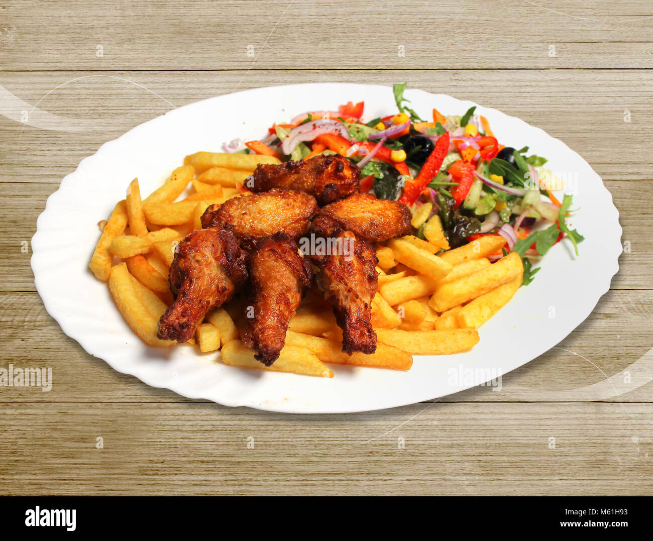 Chickennuggets with Pommes and salad in plate, Fastfood Stock Photo