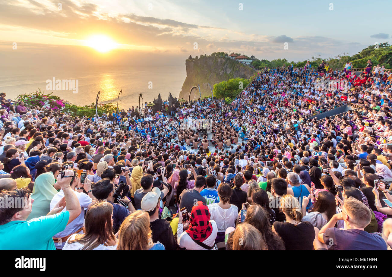 Tourists watching sunset with a traditional Balinese Kecak Dance at Uluwatu Temple in Bali Indonesia. Stock Photo