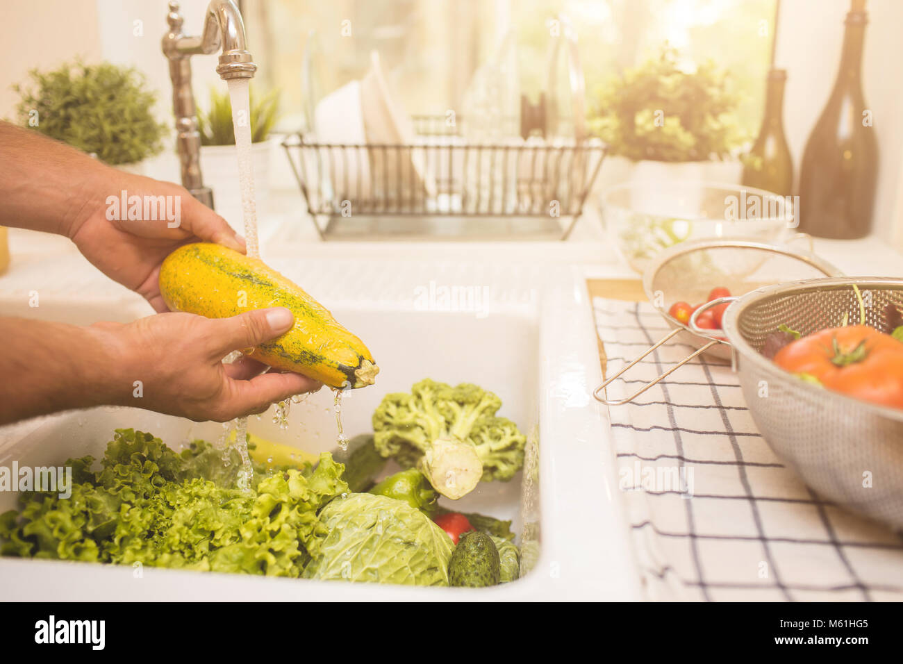 Man washing vegetables before eating Stock Photo