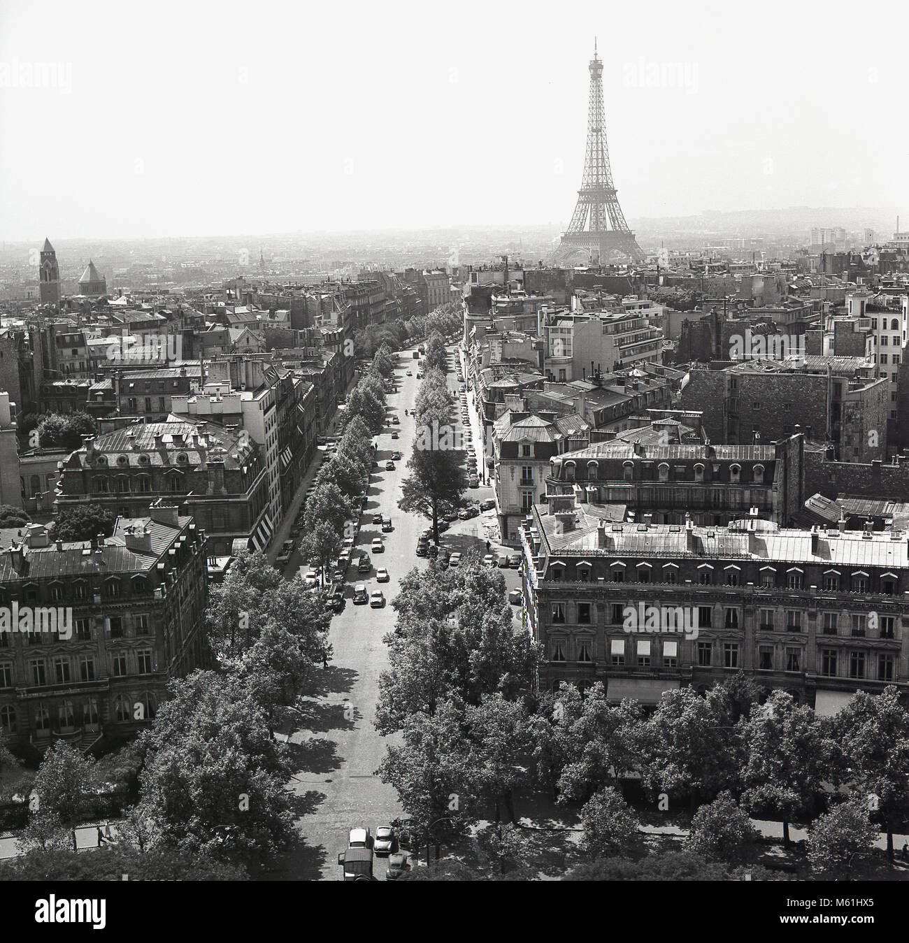 1950s, Paris, France, historical, overhead picture of the city and of a long tree-lined boulevard in Paris leading to it's most famous landmark, the Eiffel Tower, a wrought iron lattice tower constructed as the entrance to the 1889 World's fair. Stock Photo