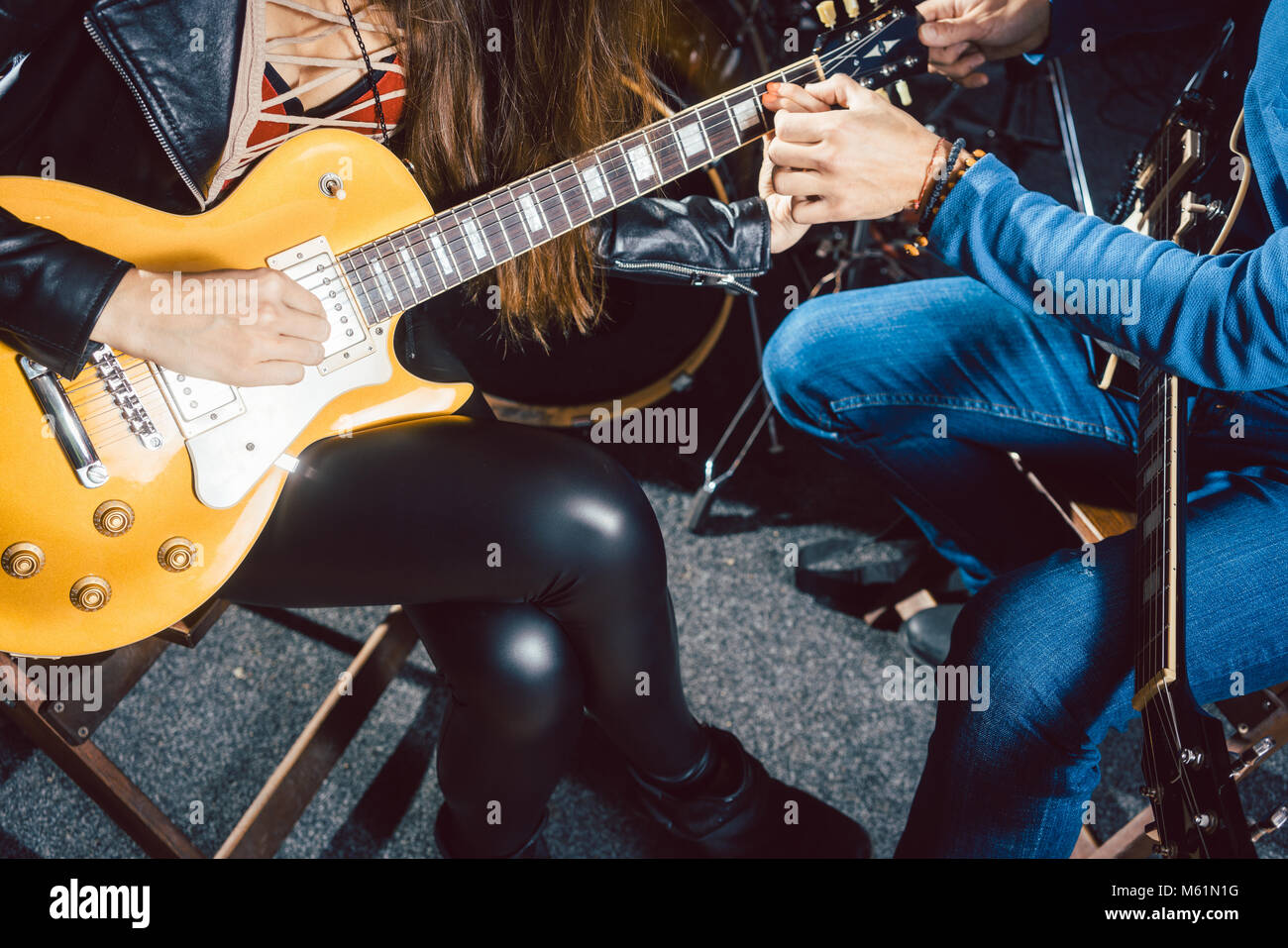 Guitar music teacher helping his student Stock Photo