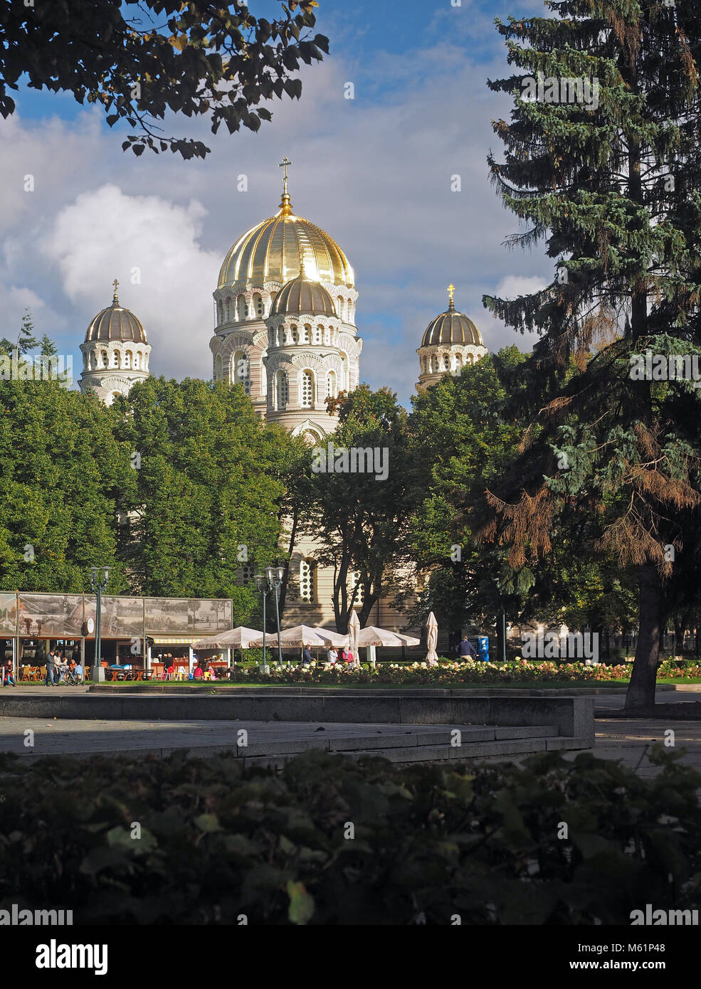 RIGA, LATVIA-SEPT. 27: The domes of The Nativity of Christ Orthodox Cathedral are seen as tourist dine and relax in Riga, Latvia, Europe on September  Stock Photo