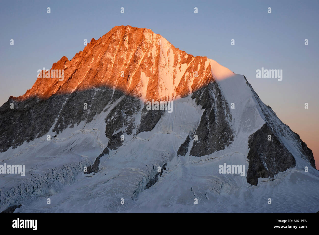 Colorful sunrise at the Bietschhorn mountain. Bernese Alps, Valais, Switzerland Stock Photo