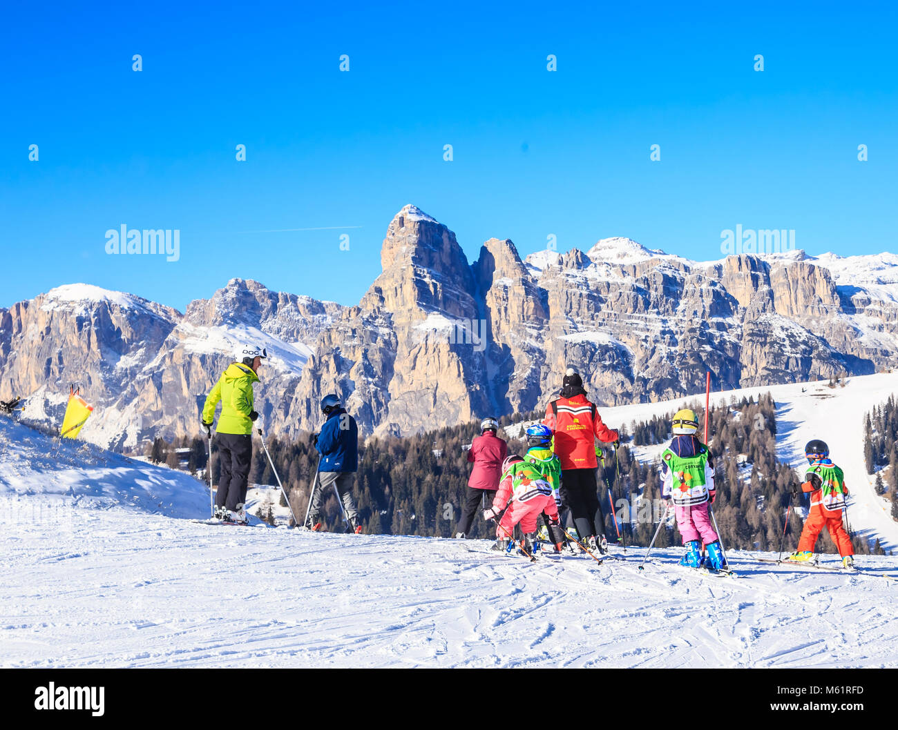An instructor with a group of children. Ski resort of Selva di Val Gardena, Italy Stock Photo