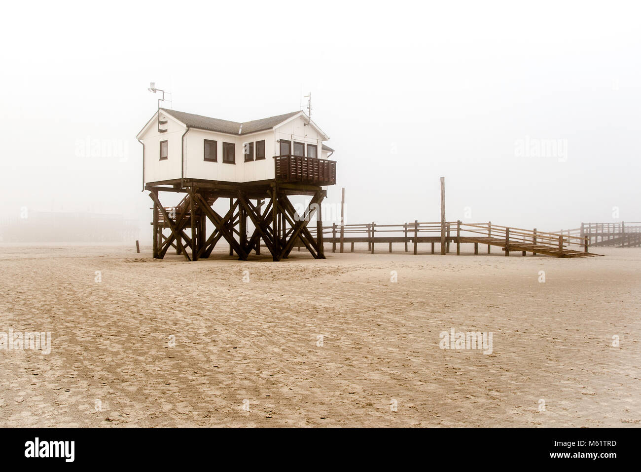 The pile dwellings rise up to seven meters above the beach. For more than 100 years, the constructions made of larch wood have shaped the beach image of St. Peter-Ording. Lake dwelling, pier house at the beach of St Peter Ording in Germany Stock Photo