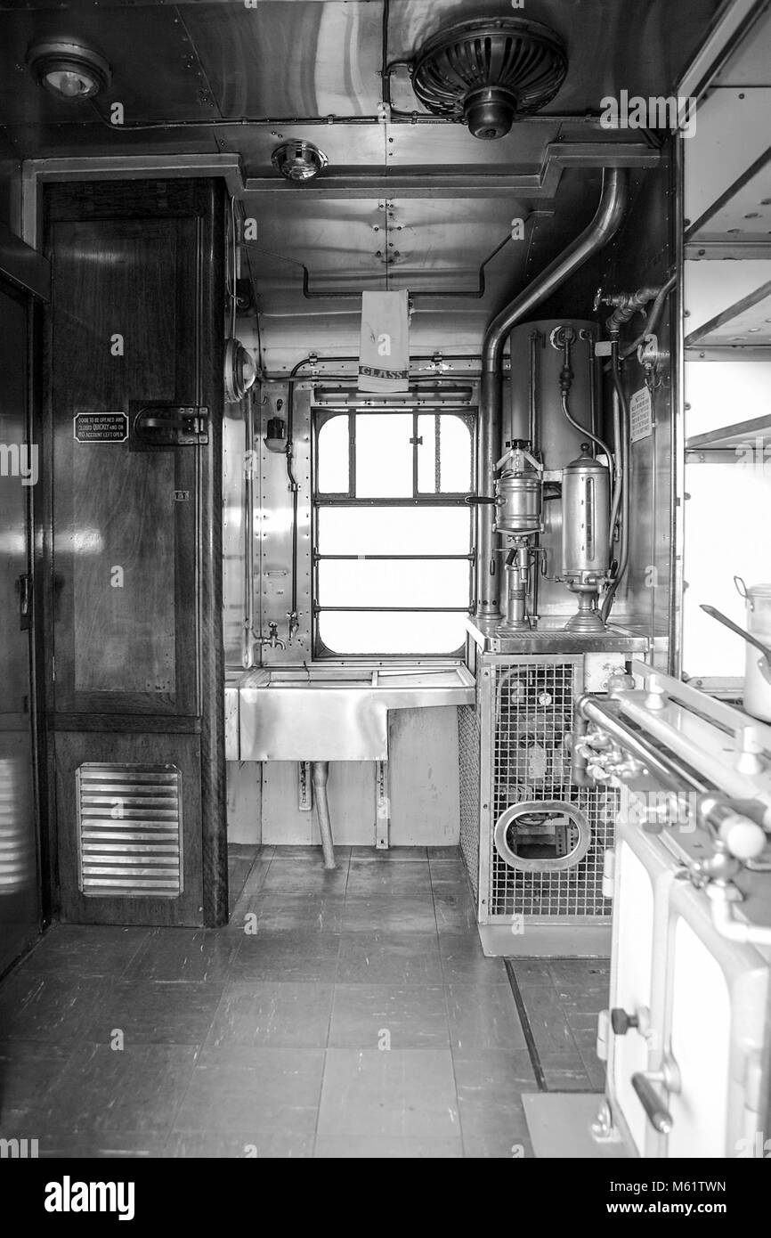 One of (26) images in this set revealing external and especially internal aspects of steam locomotive travel in Britain. Railway kitchen carriage. Stock Photo