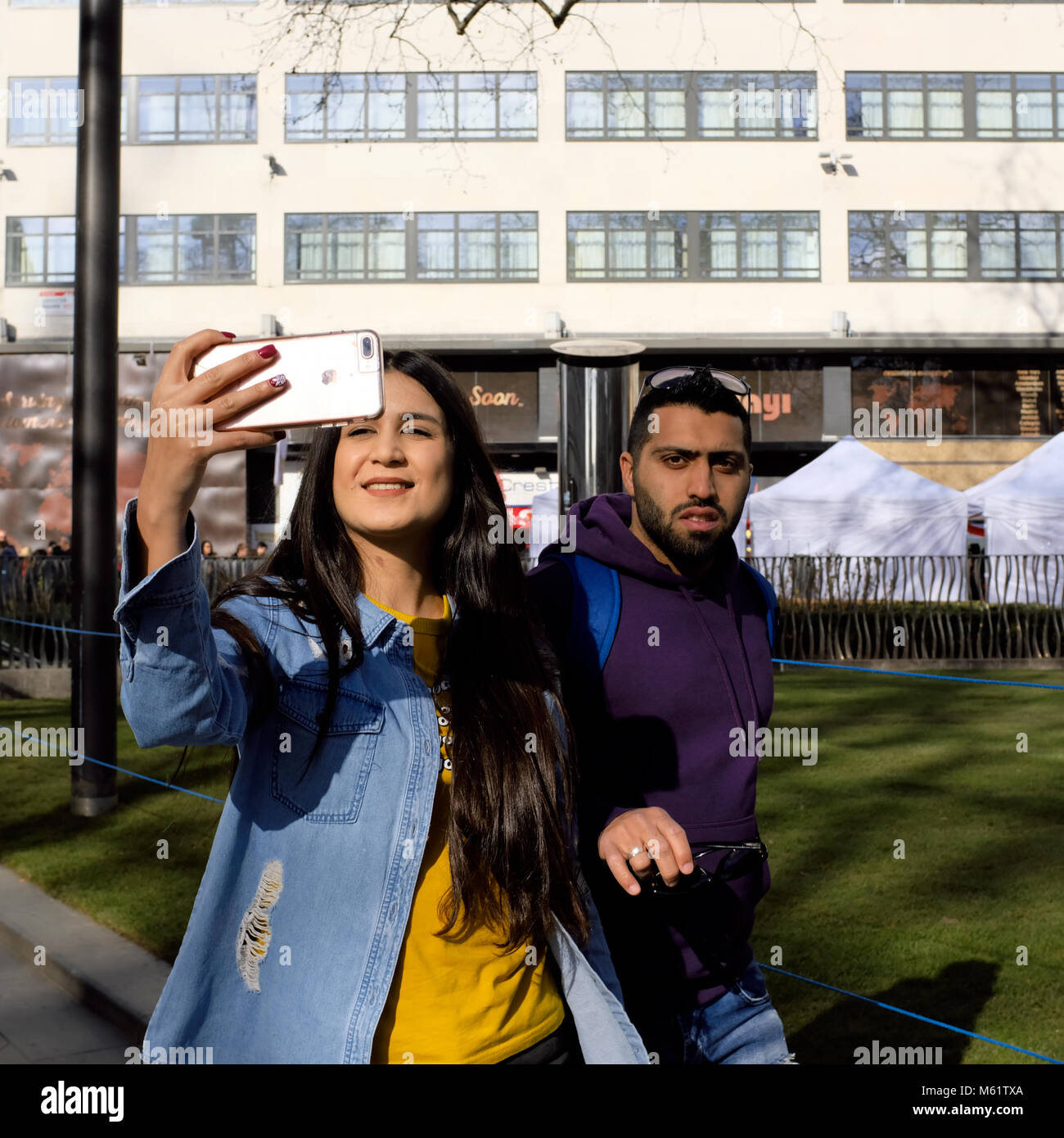 Ethnic woman taking a selfie with her mobile phone in London, England
