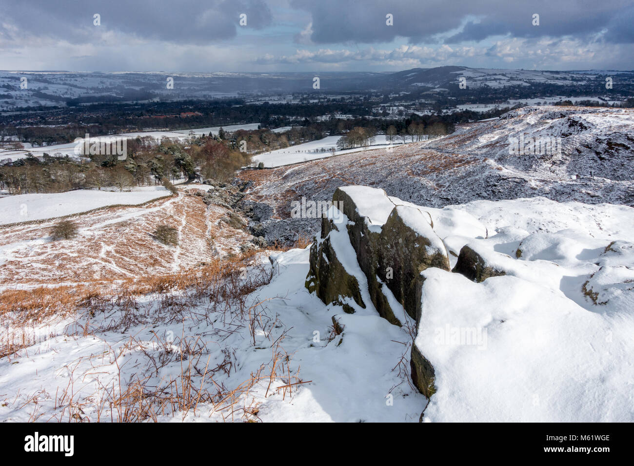Looking over the Wharfedale valley from Ilkley Moor with The Chevin on the right and Burley-in-Wharfedale below and Otley behind on a snowy day in win Stock Photo