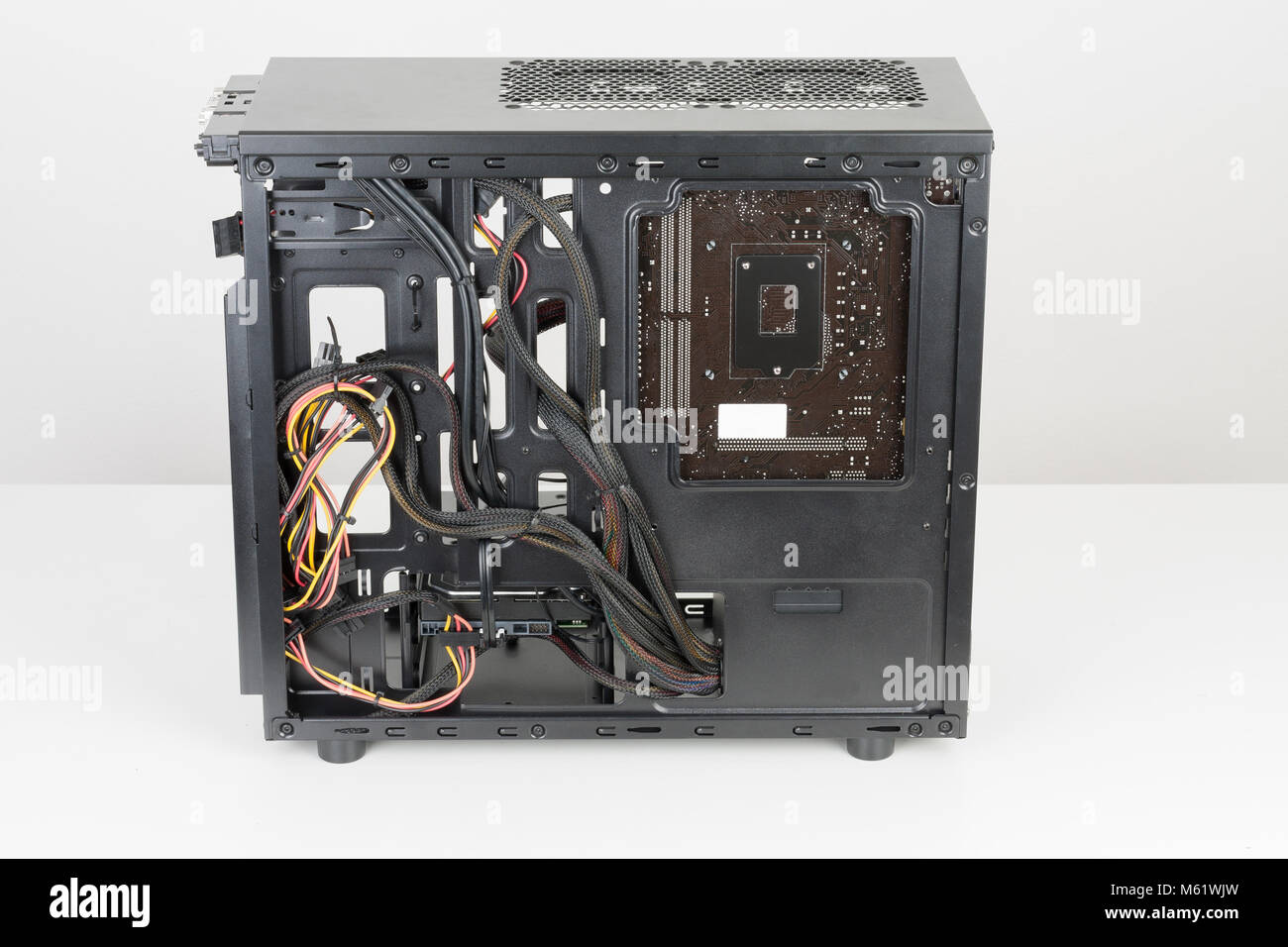 Building of PC, ATX motherboard and computer power supply unit inserted to  black midi tower case Stock Photo - Alamy