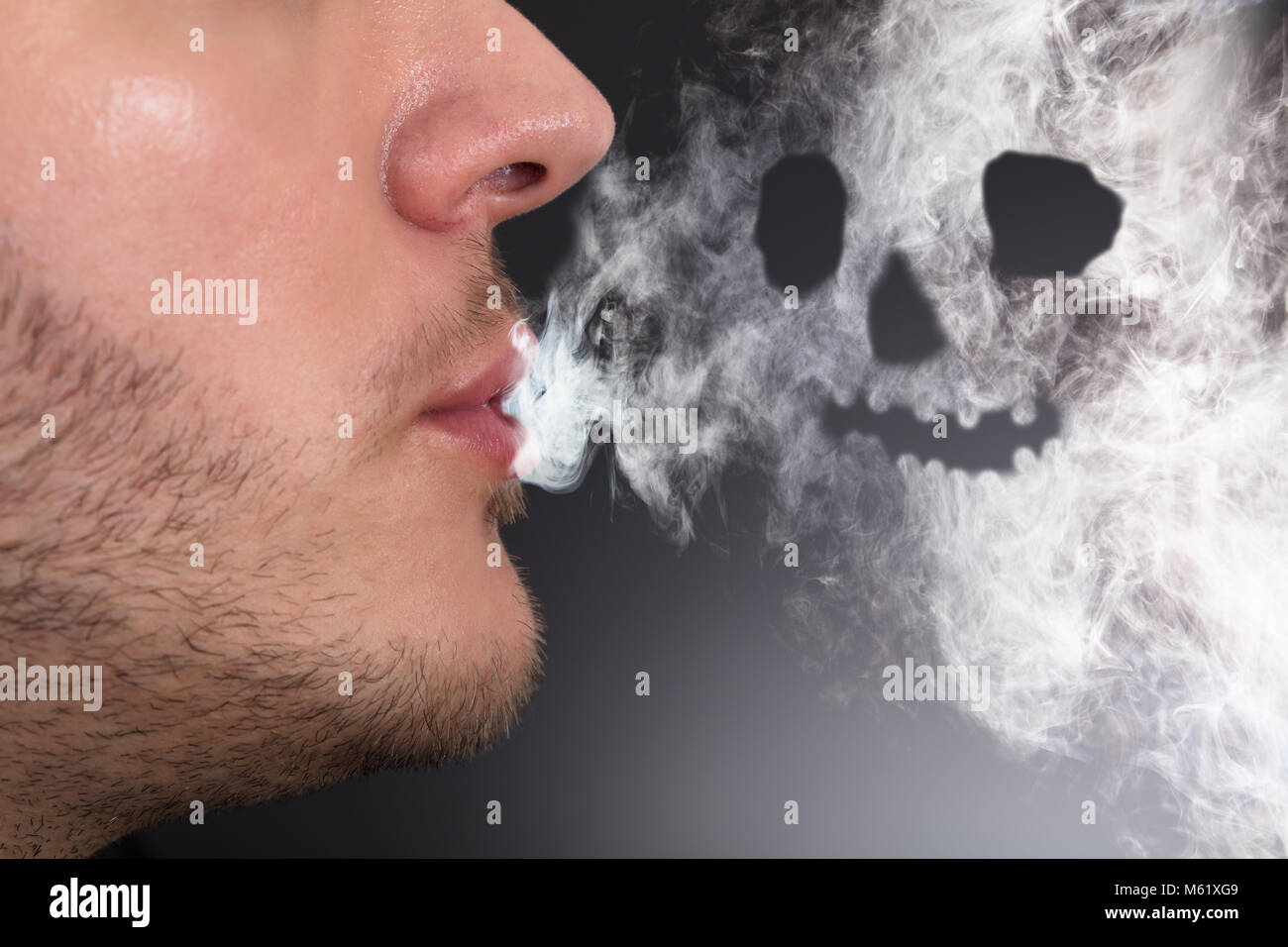 Close-up Of A Man Smoking Skull Shape Formed Stock Photo