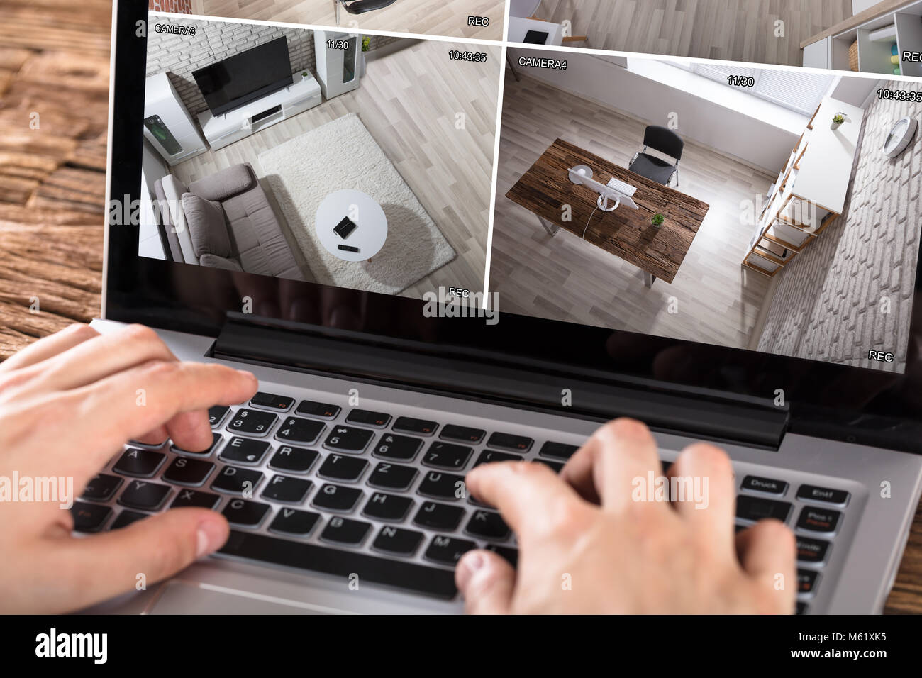 Close Up Of Person Checking Security Camera On Laptop At Desk