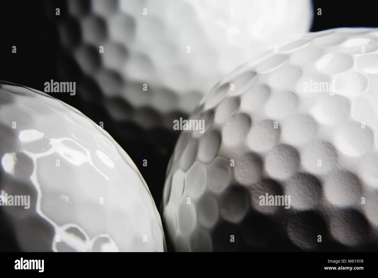 Golf ball on black background Stock Photo - Alamy
