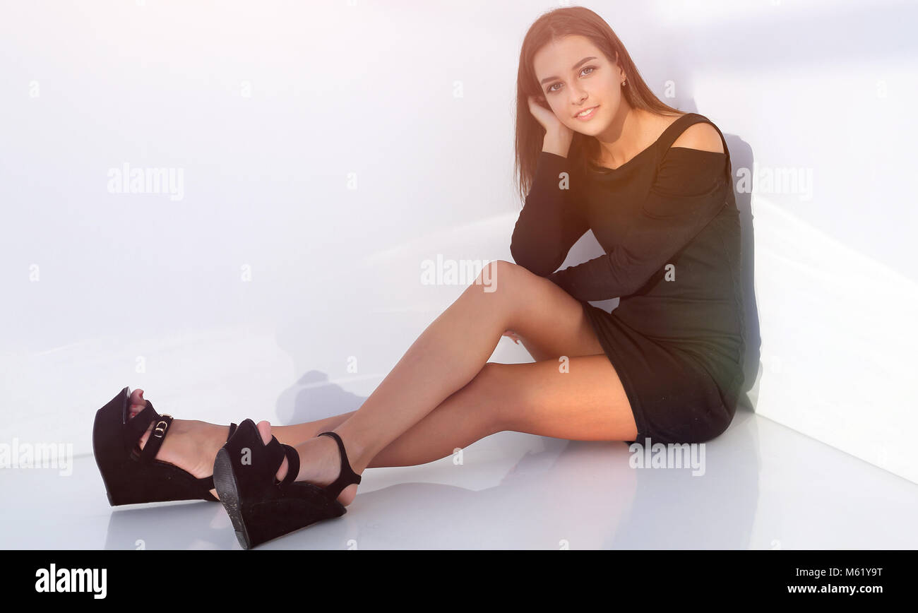 smiling young woman sitting on the floor Stock Photo - Alamy