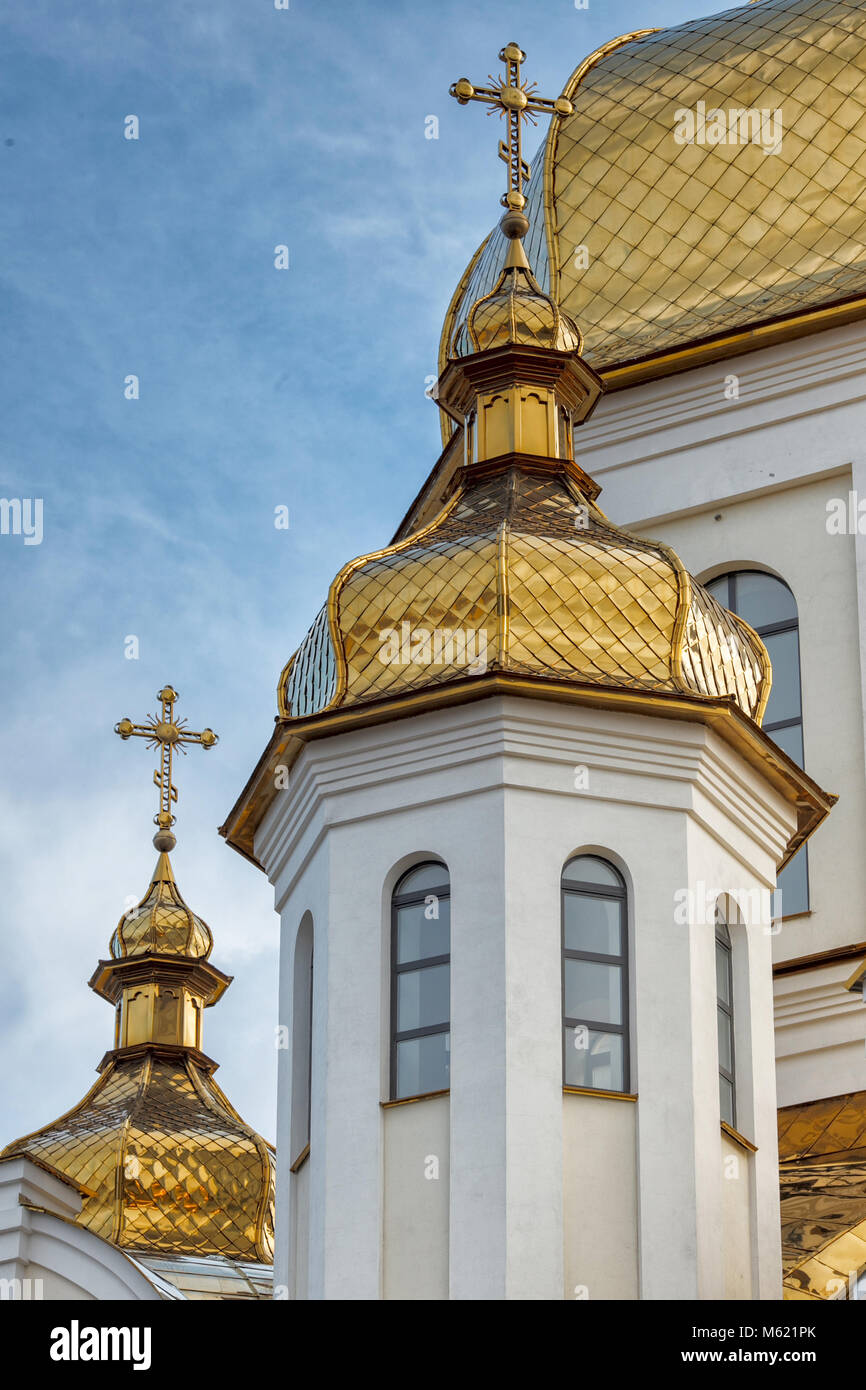 Gilded domes of orthodox Christian church shine on the blue sky ...