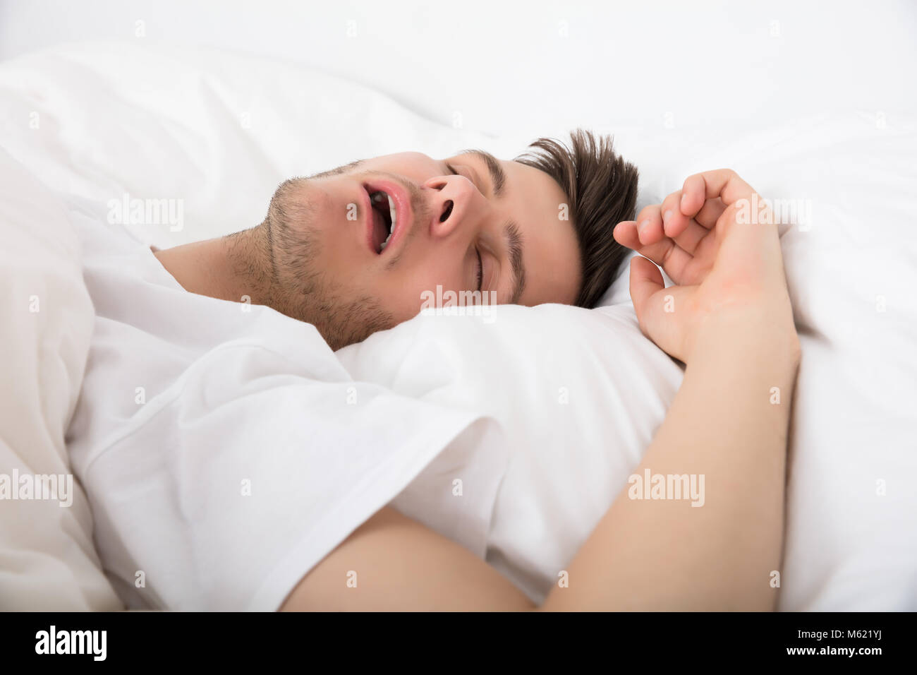 View Of Tired Young Man Snoring While Deep Sleeping In Bed Stock Photo Alamy