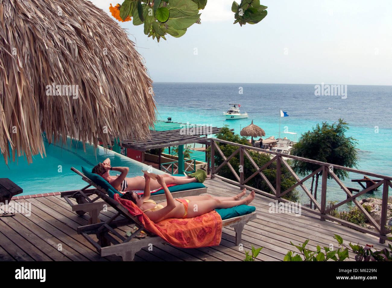 Tourists sunbathing beside the pool, Habitat Curacao resort, Curacao, Netherlands Antilles, Caribbean Stock Photo