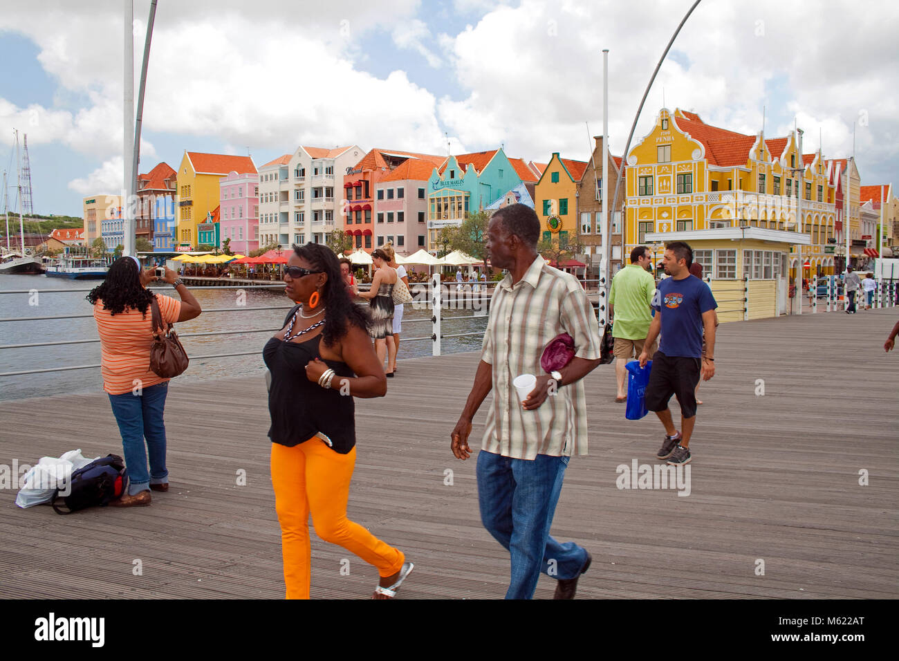 People on Queen Emma bridge, behind the trade arcade, colourful row of houses, Willemstad, Curacao, Netherlands Antilles, Caribbean, Caribbean sea Stock Photo