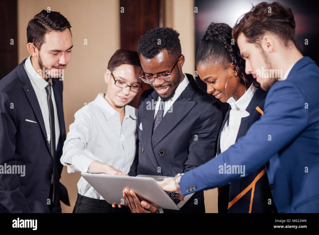 Using Computer With Partner smart business partners using laptop at meeting Stock Photo - Alamy
