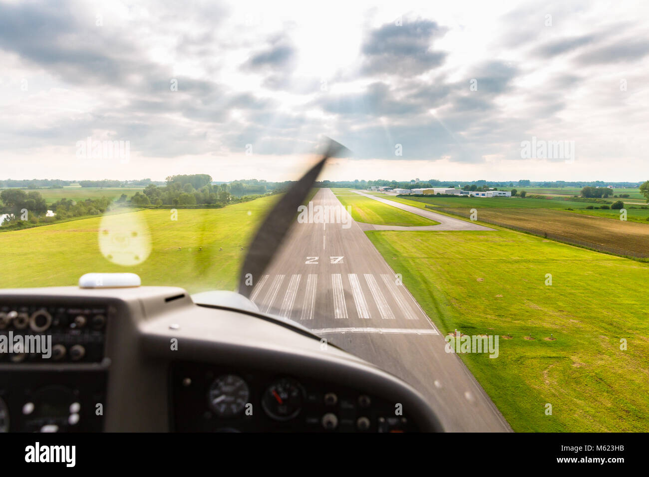 Sport pilot landing on airfield strip Stock Photo