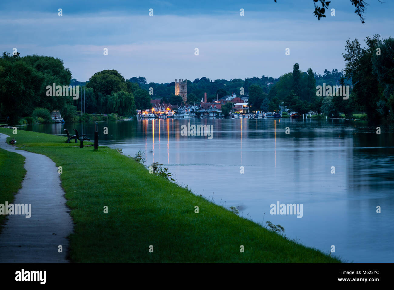 A view of Henley on Thames from the Thames Path during sunset, St Mary's Church tower rising from the town Stock Photo