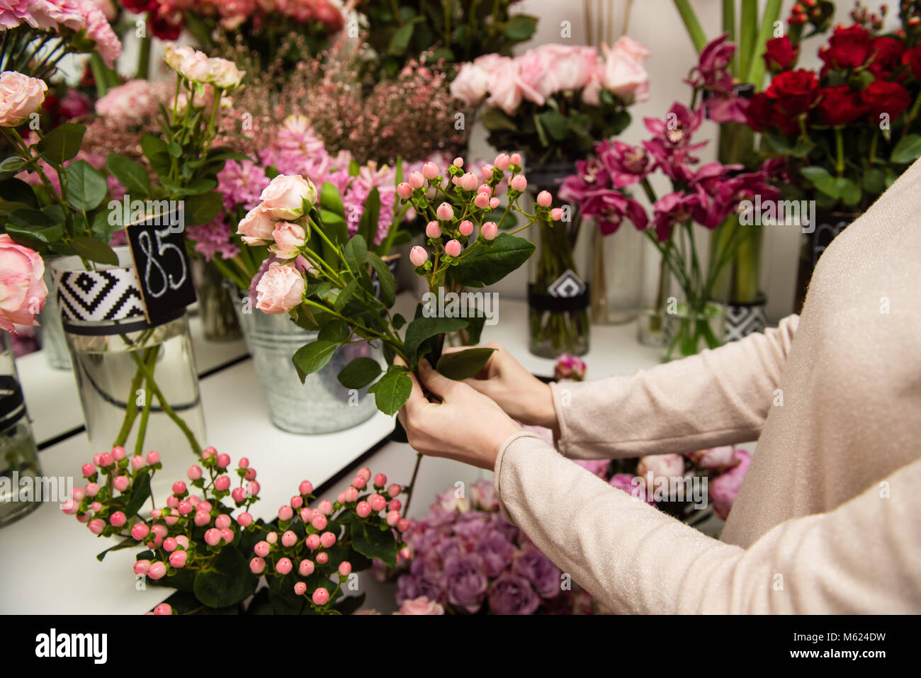 Female hands in shop with flower background Stock Photo