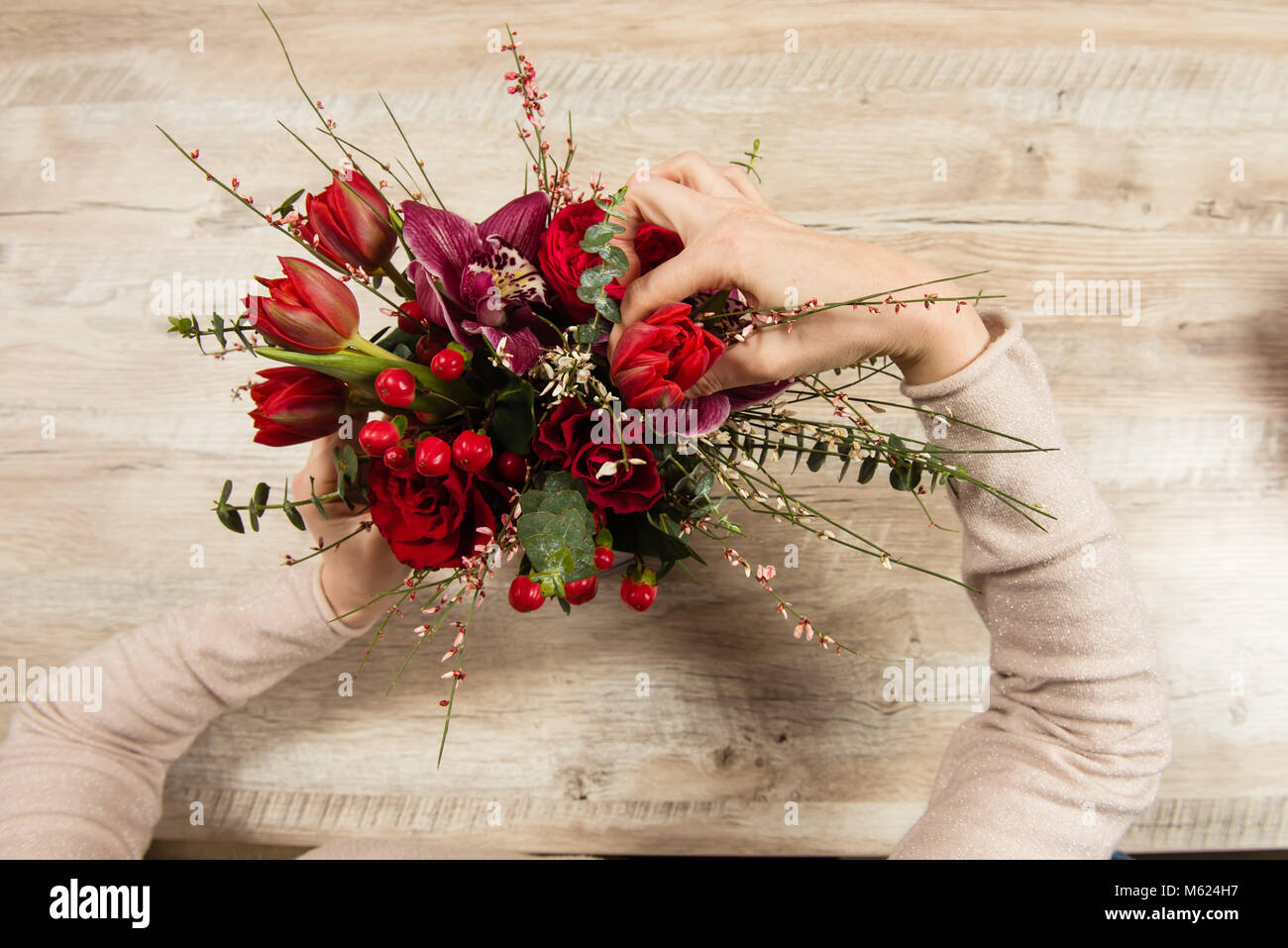 Female hands arrange red bouquet Stock Photo Alamy