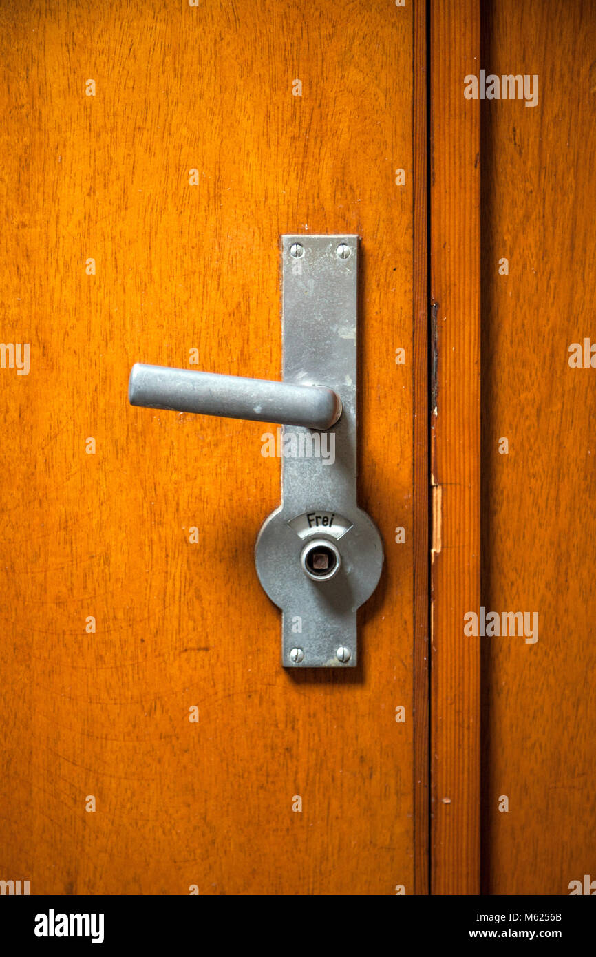 Closed vintage wooden toilet door with 'free' sign. Stock Photo
