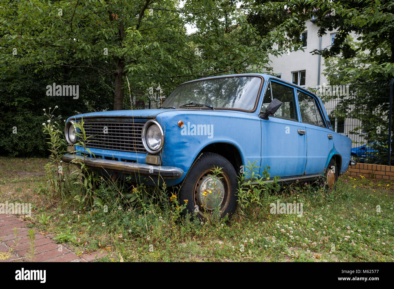 Abandoned Russian car wreck (Lada 1200s) on a car park in Berlin. Stock Photo