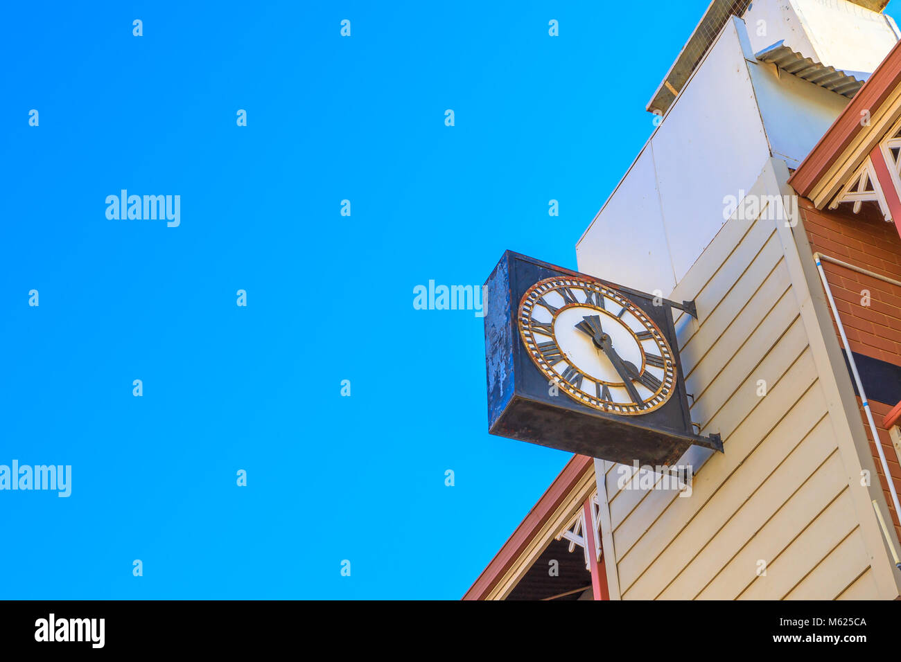 Close-up of old clock on a historic building constructed in 1908 on Avon Terrace in York, in the east tourist town of Perth in Avon Valley, Western Australia. Blue sky with copy space. Stock Photo