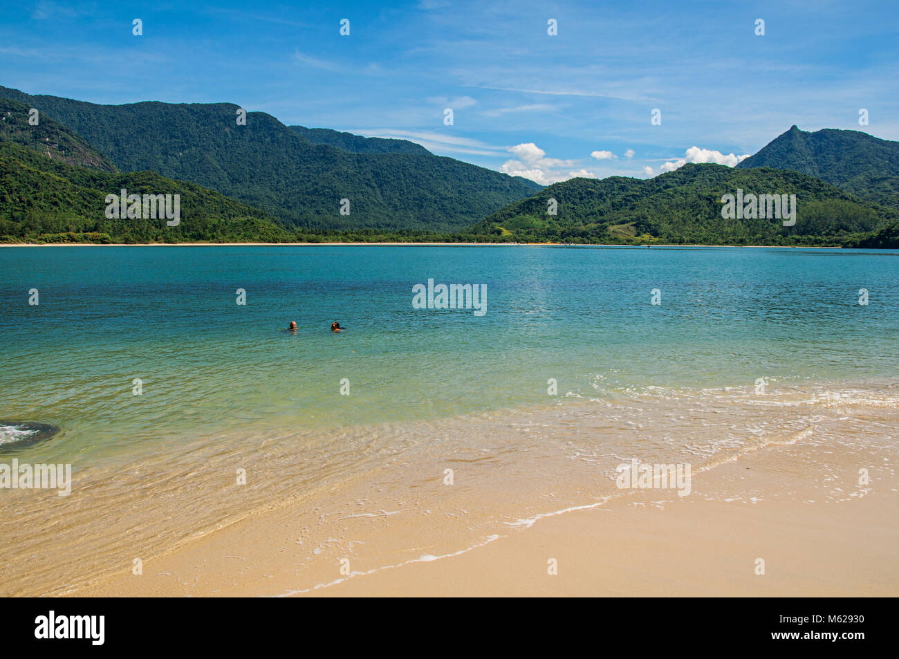 View of beach, sea and forest on sunny day in Ilha do Pelado, a tropical beach near Paraty, an historic town totally preserved in the Brazilian coast. Stock Photo