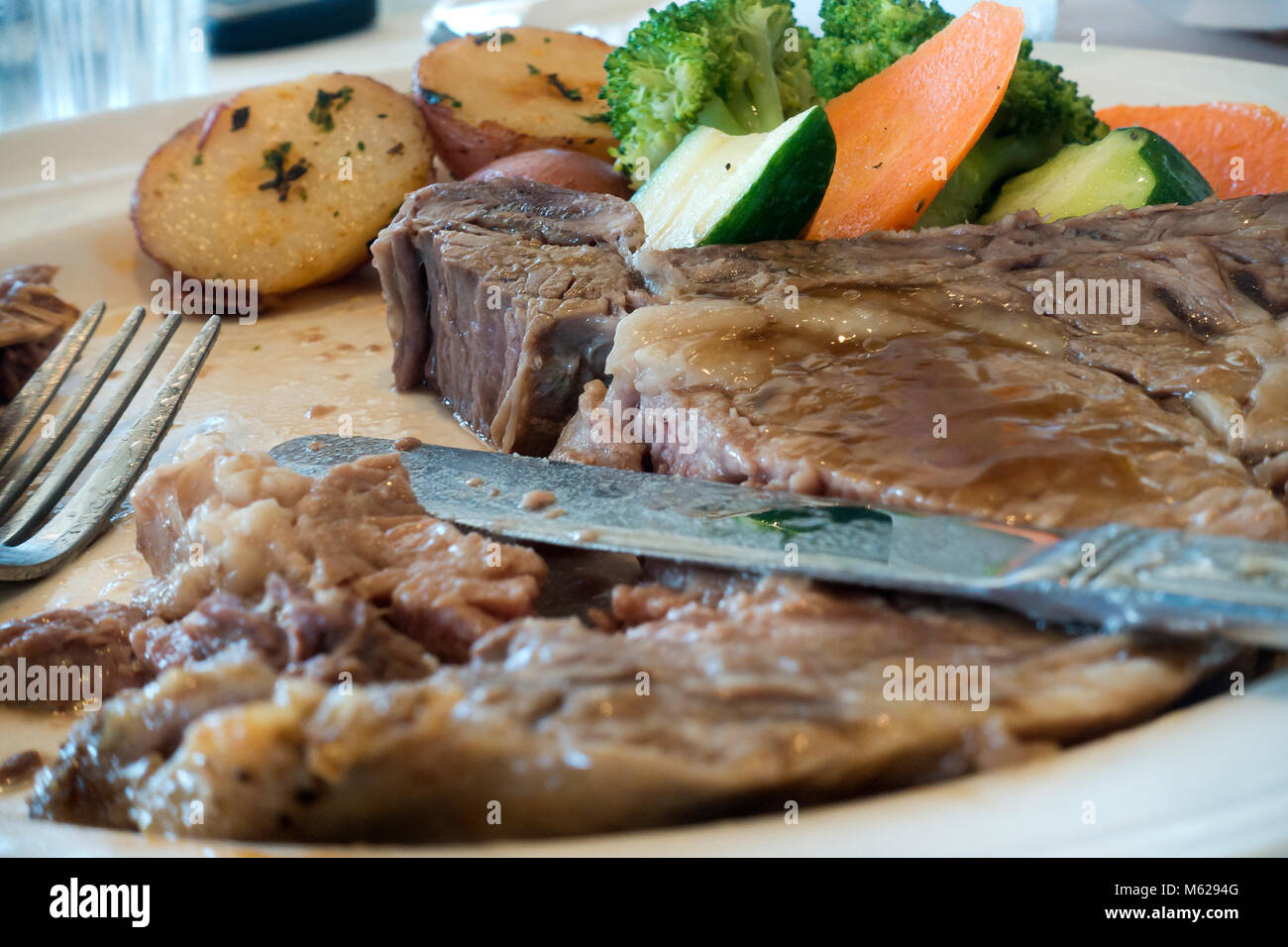 Half eaten prime rib steak on plate - USA Stock Photo