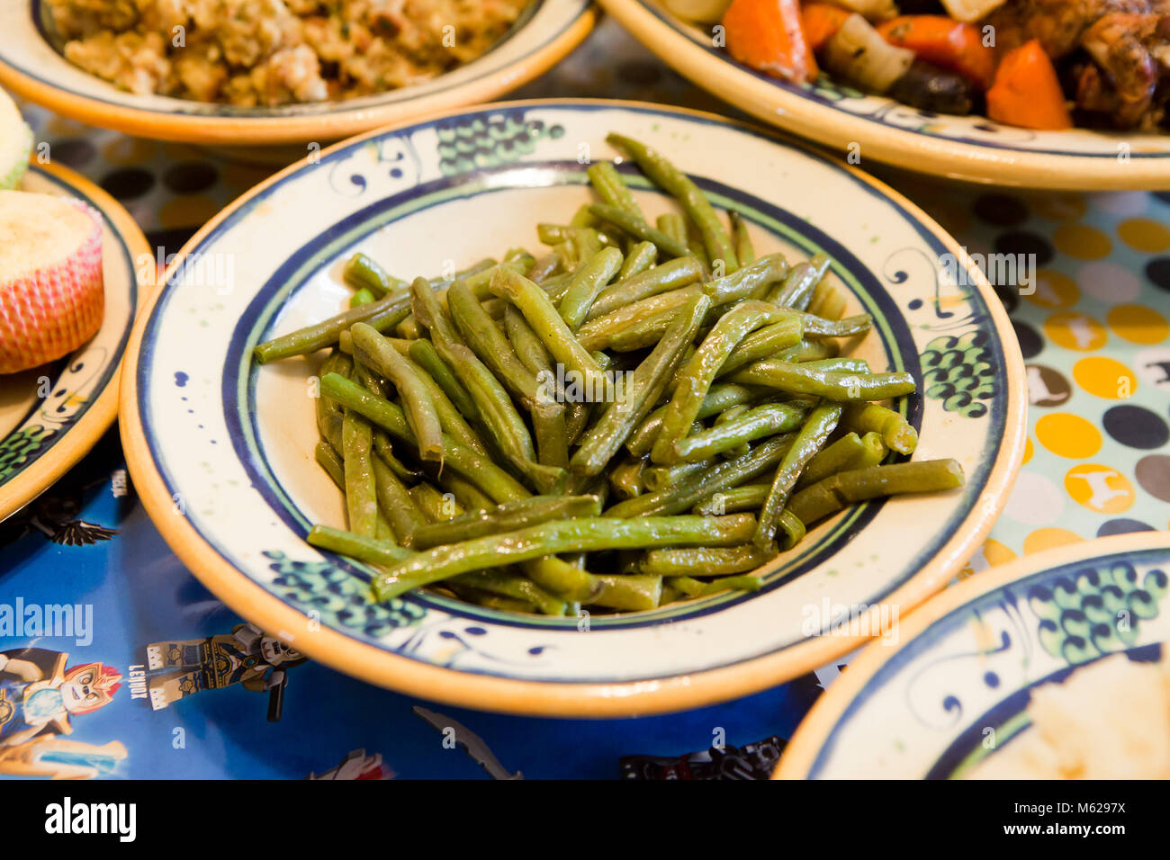 A plate of sauteed butter and garlic green beans on dinner table USA