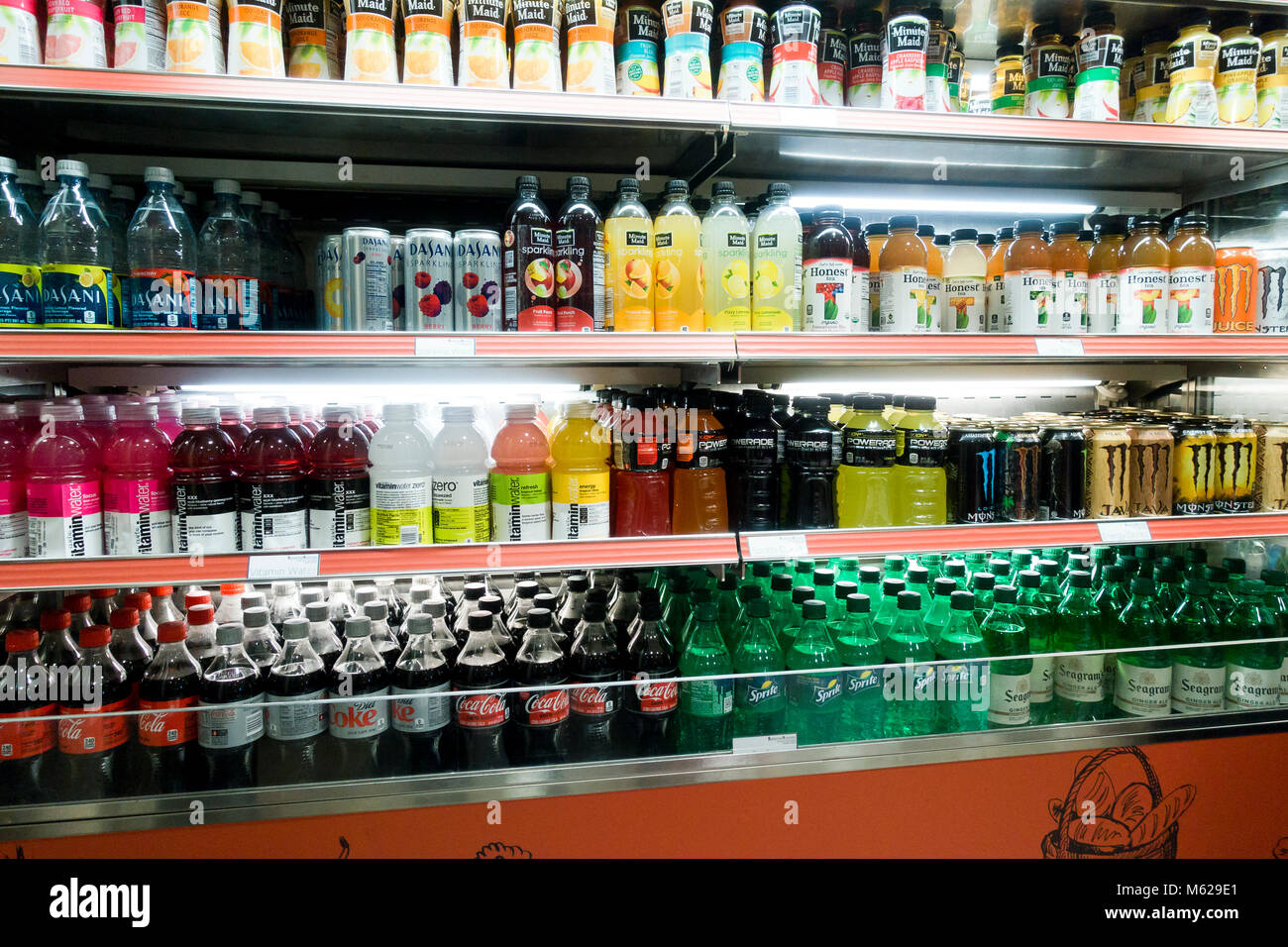 Cold carbonated drinks in open display refrigerator at a convenience