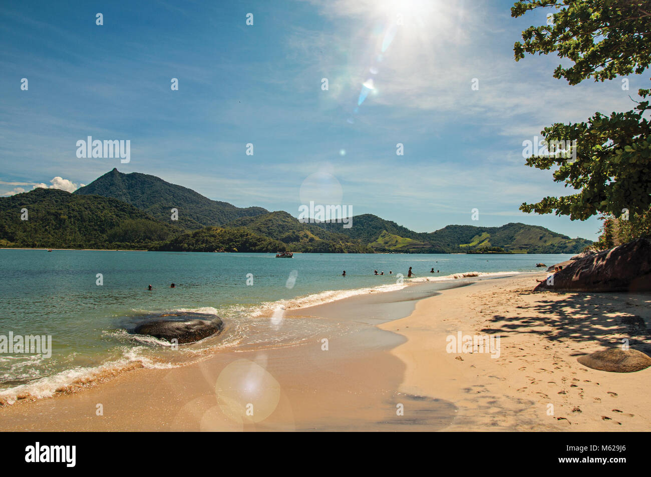 View of beach, sea and forest on sunny day in Ilha do Pelado, a tropical beach near Paraty, an historic town totally preserved. Retouched photo Stock Photo