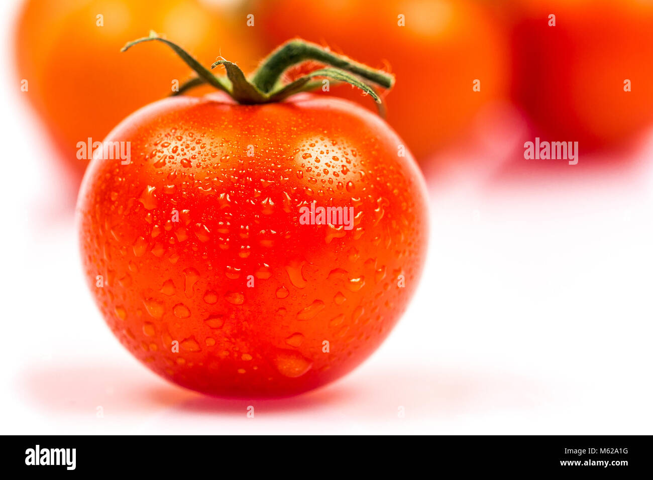 Tomato with water drops isolated on white background Stock Photo - Alamy