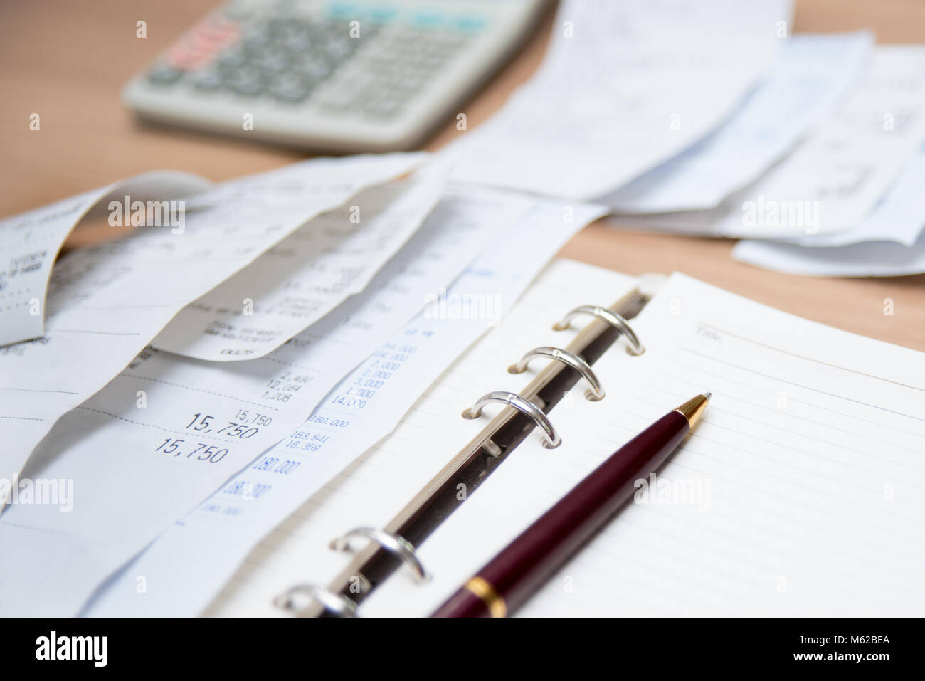 Checking receipt. Finance concept with receipts, calculators, and notes. Defocused. Stock Photo